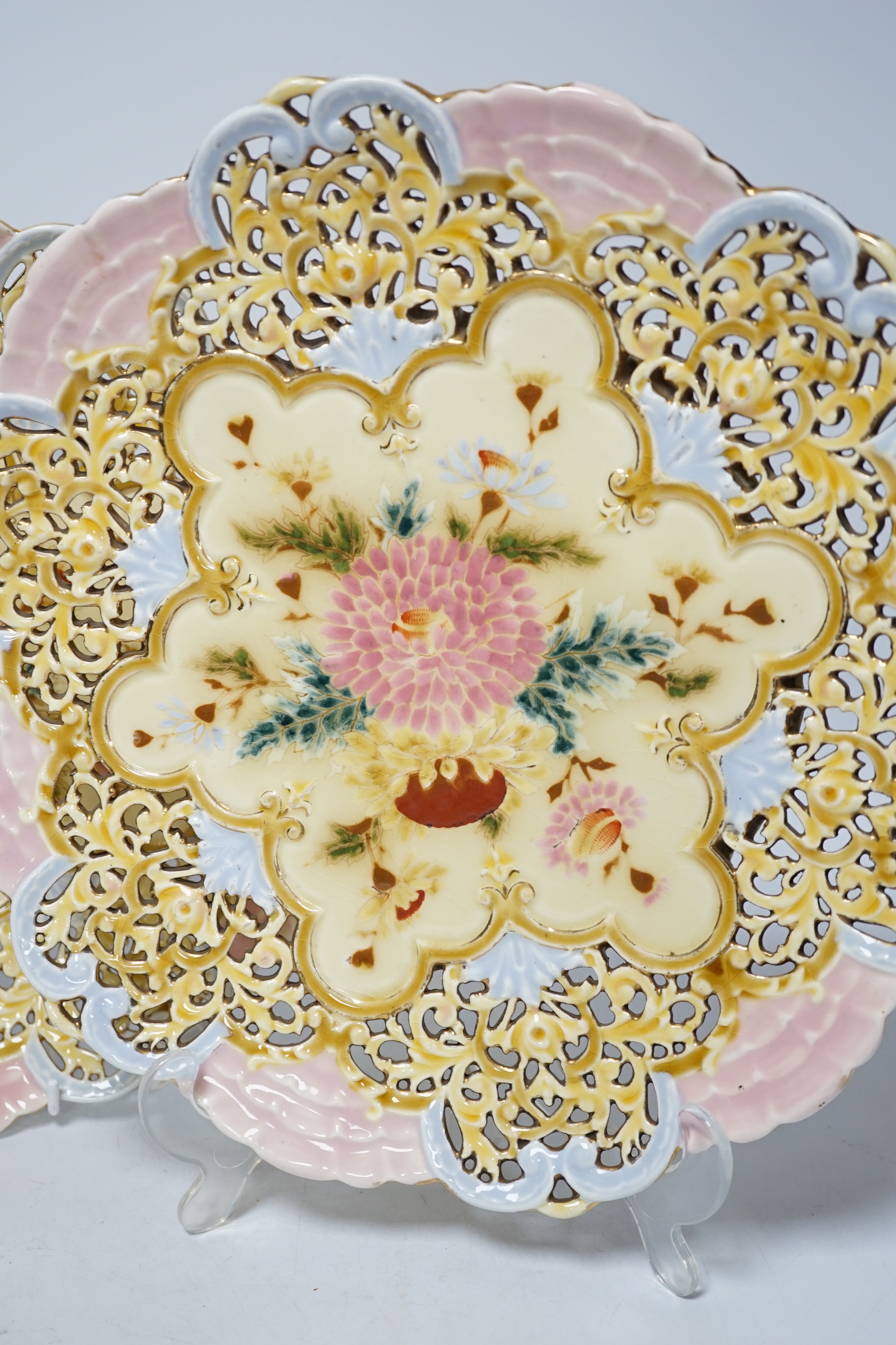 A pair of Zsolnay pierced floral and gilt decorated dishes, 31cm high